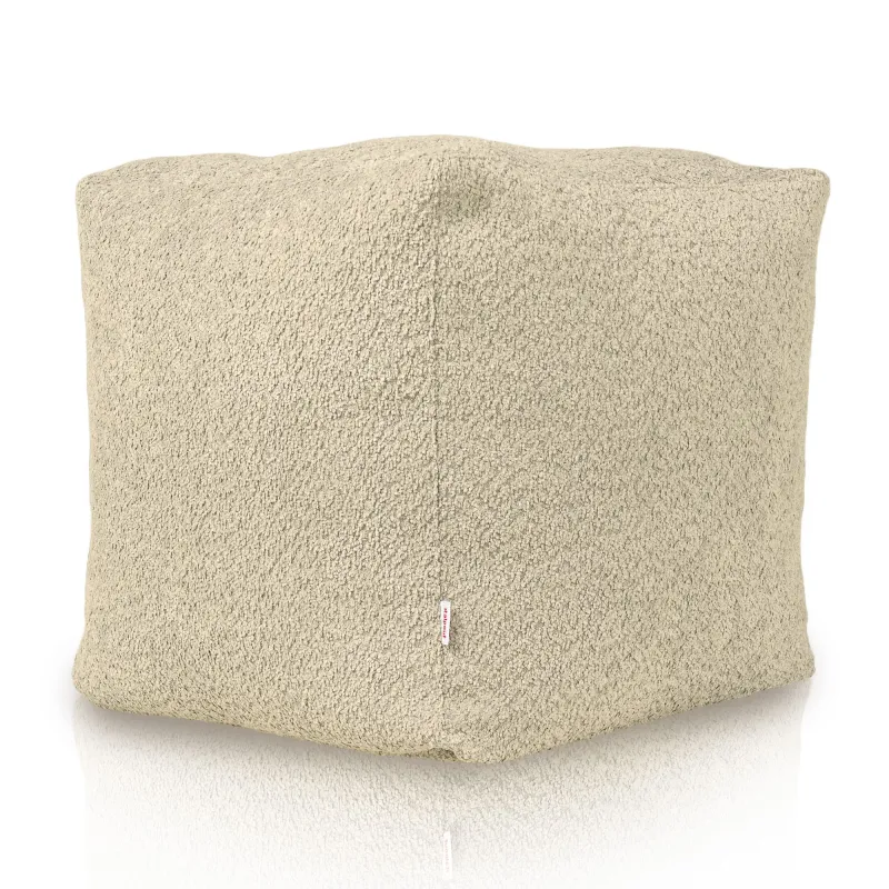 Soft beige pouf with boucle texture for cozy living areas