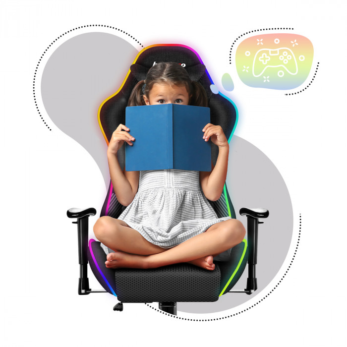 A boy sitting on the Huzaro Ranger 6.0 RGB Mesh gaming chair holding an open book in his hands