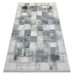 Modern blue geometric rug with fringes, perfect for living room decor